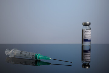 Covid vaccine with inoculation syringe with copyspace. Covid-19 vaccination set with syringe and inoculation vial. Covid treatment photo for healthcare promotion. Vaccines are effective in preventing