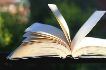 Open book in a garden. Selective focus.