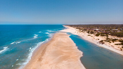 Beautiful view of the clear blue skies over the ocean and the sand in  Canelones, Uruguay