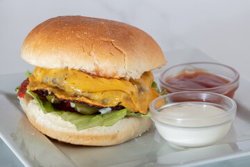 Perfect hamburger classic burger american cheeseburger with cheese, tomato and lettuce isolated on a white background
