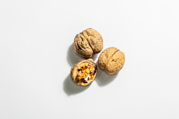 Whole and half walnuts isolated on white background