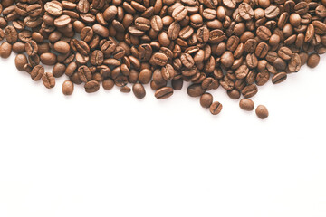 top view of fresh coffee beans on white background with copy space.