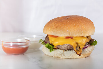 Perfect hamburger classic burger american cheeseburger with cheese, tomato and lettuce isolated on a white background
