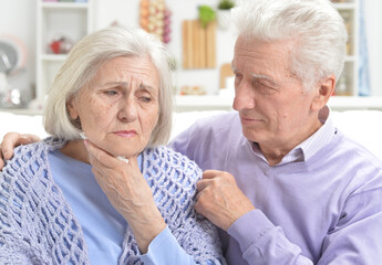 Portrait of sick  elderly woman and man  at home