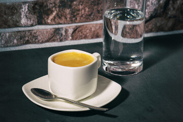 a cup of morning coffee and a glass of cold water