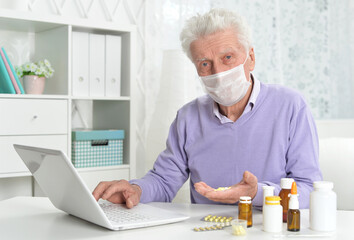 Portrait of sad sick senior man with facial mask