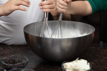 Kids baking cookies in house kitchen . Close up child hands preparing cookies using cookie.