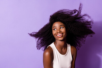 Portrait of attractive cheerful dreamy girl air blowing hair good mood isolated over bright violet purple color background