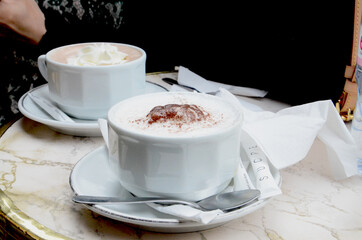 Two cups of Cappuccino served on terrace table of a coffee shop in Paris