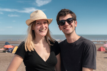 Close-up of young couple in love on the beach during their summer vacation.