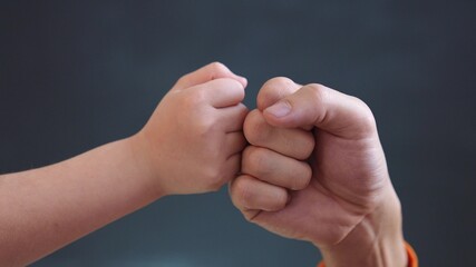 teamwork business concept. fist to fist commit solidarity a respect and brotherhood gesture. business close-up kid team hands fists. happy family partnership friendship teamwork. father and daughter