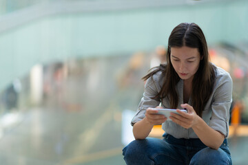 young woman uses a smartphone to work and communicate,