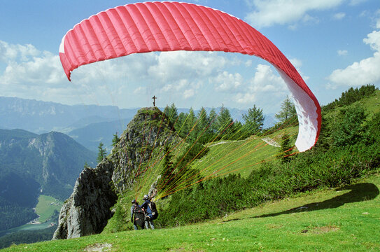 Skydiver in pairs in the Alps just before takeoff. It is now time to take off! Alpine panorama in the background. Since one gets equal to fly itself. Normal perspective. 