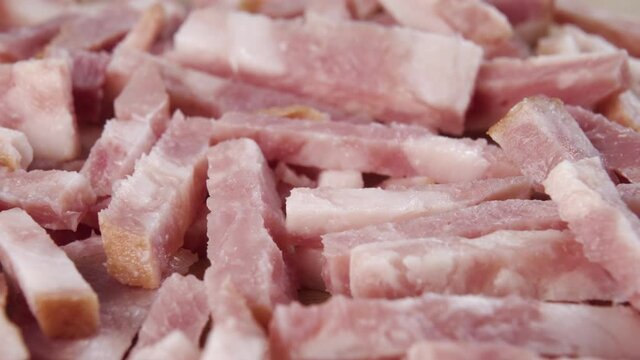 Chopped slices of cooked bacon close-up. Macro shot. Dolly Shooting