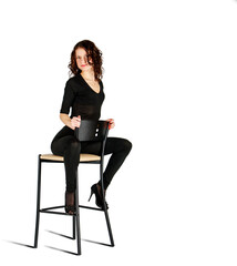 young girl posing while sitting on a chair in the studio