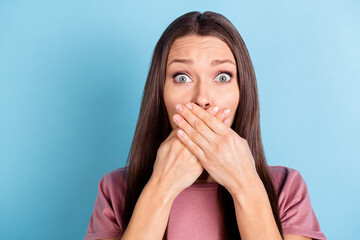 Photo of scared frightened young woman cover mouth hands silence secret isolated on blue color background