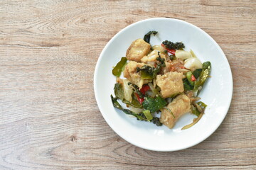 deep fried slice striped snake head fish with pepper and finger root on dish
