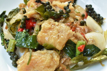 deep fried slice striped snake head fish with pepper and finger root on dish