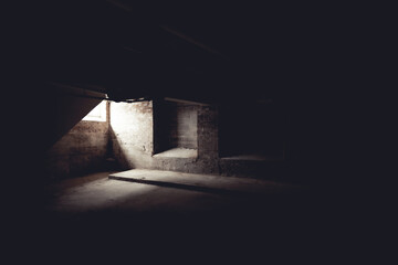 Light shining through a window into the dark basement