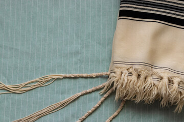 A close-up photo of a tallit, on a light background