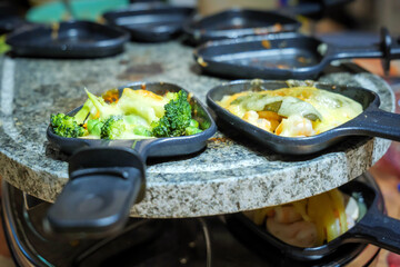 family dinner table share food on raclette