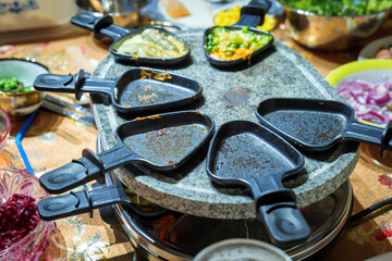 family dinner table share food on raclette