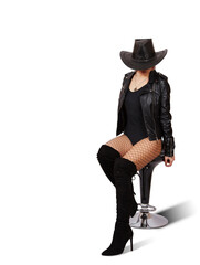 young woman in hat, leather jacket, mesh tights and boots posing sitting on chair