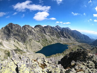 Nice view from the mountain with the lake beneath the hill. Rocky surroundings in the mountain area.
