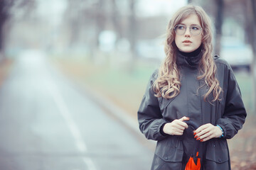 Fototapeta na wymiar seasonal autumn portrait, sad girl with umbrella, november seasonal virus immunity on a walk
