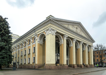 Fototapeta na wymiar Poltava, Ukraine - April 14, 2021: Majestic antique columns of the ancient facade of the building of the Gogol Drama Theater in the city of Poltava, Ukraine. Historical and cultural center