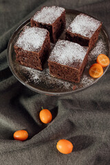 A stack of chocolate brownies on dark gray background, homemade bakery and dessert