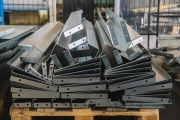 metal blanks bent on a bending machine in factory warehouse
