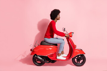 Fototapeta na wymiar Full size profile side photo afro american pretty woman ride motorcycle isolated on pastel pink color background