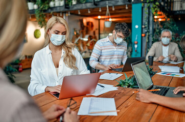 Group of people working in office during Covid-19