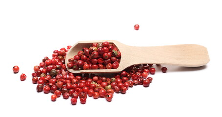Red peppercorn pile with wooden spoon isolated on white background