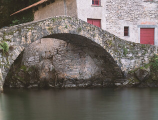 Amazing medieval arch bridge at Como lake.Nesso,italian lakes,Lombardy,Italy