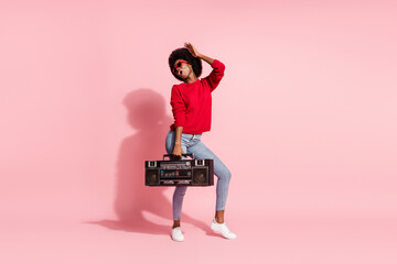Fototapeta premium Full body photo of excited funny dark skin person hold boombox partying isolated on pink color background
