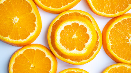 Small and big orange slices. Sliced orange on white background. Weaker, smaller and different