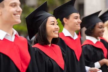 Multiracial group of graduates having graduation ceremony, closeup