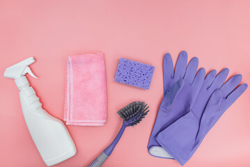 Cleaning tools on pink background, top view.