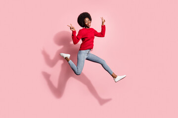 Fototapeta na wymiar Full length body size view of attractive trendy cheerful girl jumping showing v-sign running isolated over pink pastel color background