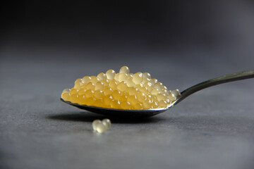 Pike caviar or roe in spoon on gray background