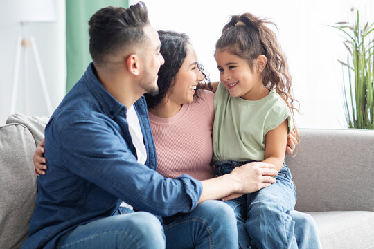 Happy Middle Eastern Parents Playing With Their Little Daughter At Home