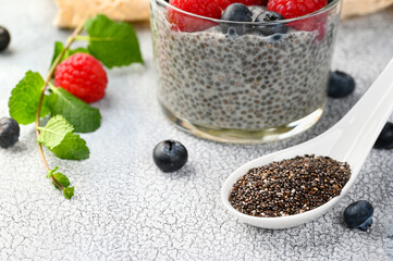 Chia seeds with Healthy chia pudding with coconut milk and fresh berry in a glass