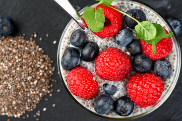 Healthy chia pudding with coconut milk and fresh berry in a glass