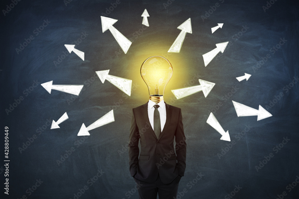 Poster Idea and solution concept with businessman with glowing lightbulb instead of head with white arrows directed in different directions on blackboard background