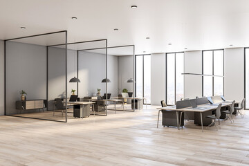 Sunny open space office room with workspaces divided by glass partitions, city view from high floor and light walls and ceiling