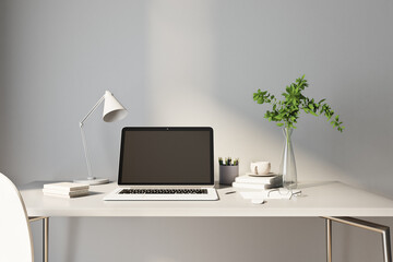 Stylish sunny workspace at home with laptop on white table on blank grey wall background. 3D rendering, mockup