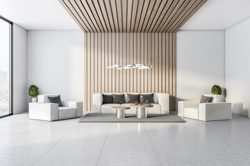 Modern waiting area in a luxuty hotel lobby, with sofa, white walls and concrete floor and big window