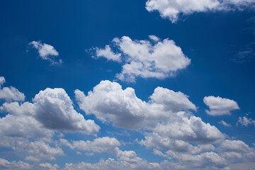 Naklejka na ściany i meble The blue sky with fluffy clouds